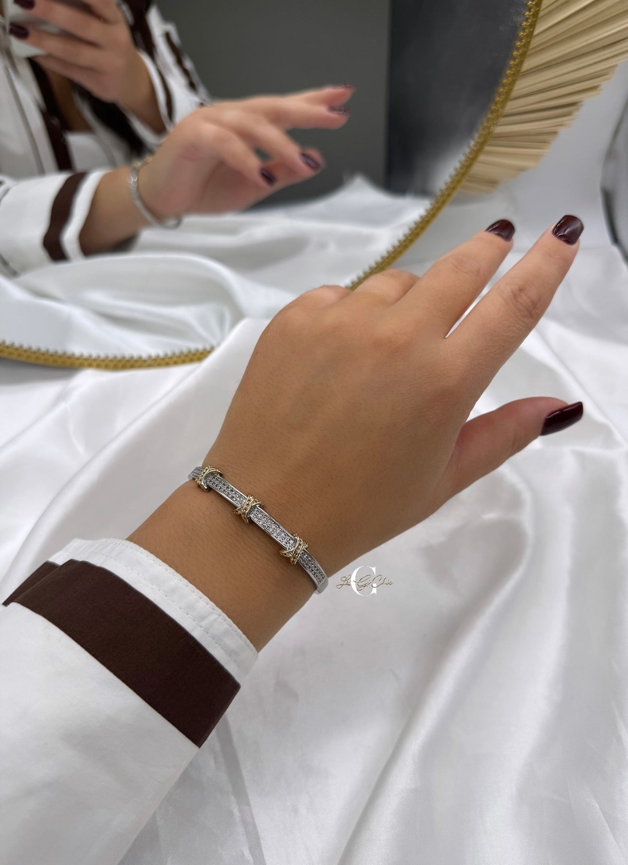 Bracciale “rigido con fascia di zirconi e incroci oro”